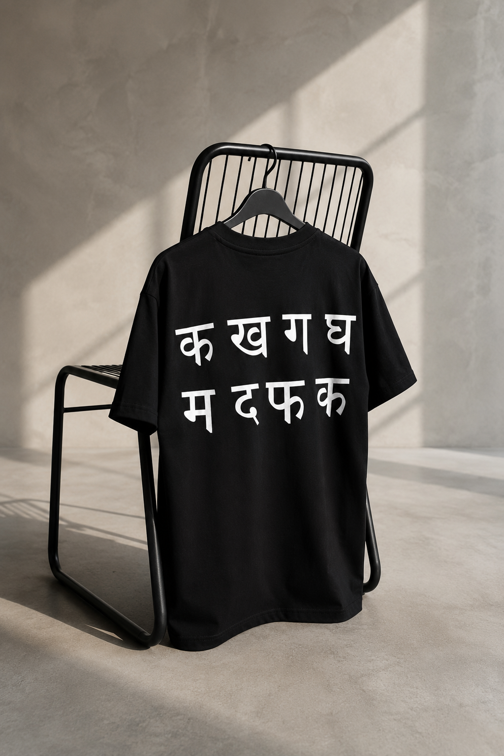 Black oversized unisex T-shirt featuring a bold Hindi typography back print on heavyweight French Terry cotton.