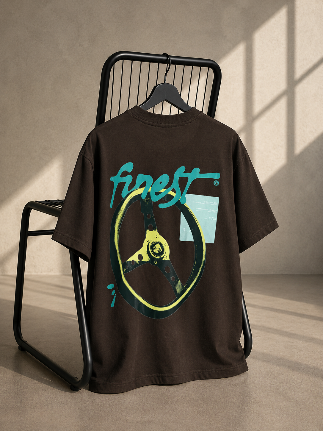 Brown oversized unisex T-shirt featuring a bold Finest steering wheel inspired graphic back print on heavyweight French Terry cotton.