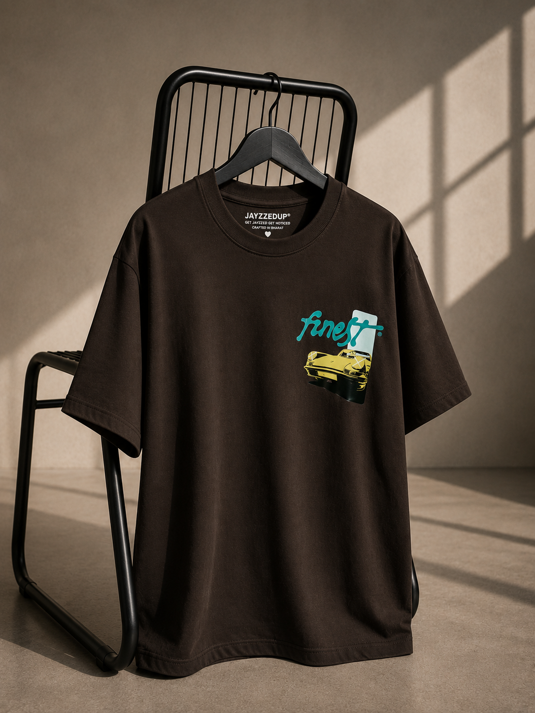 Brown oversized unisex graphic T-shirt featuring a minimal Finest automotive-inspired chest graphic, made from 220–240 GSM bio-washed French Terry cotton.