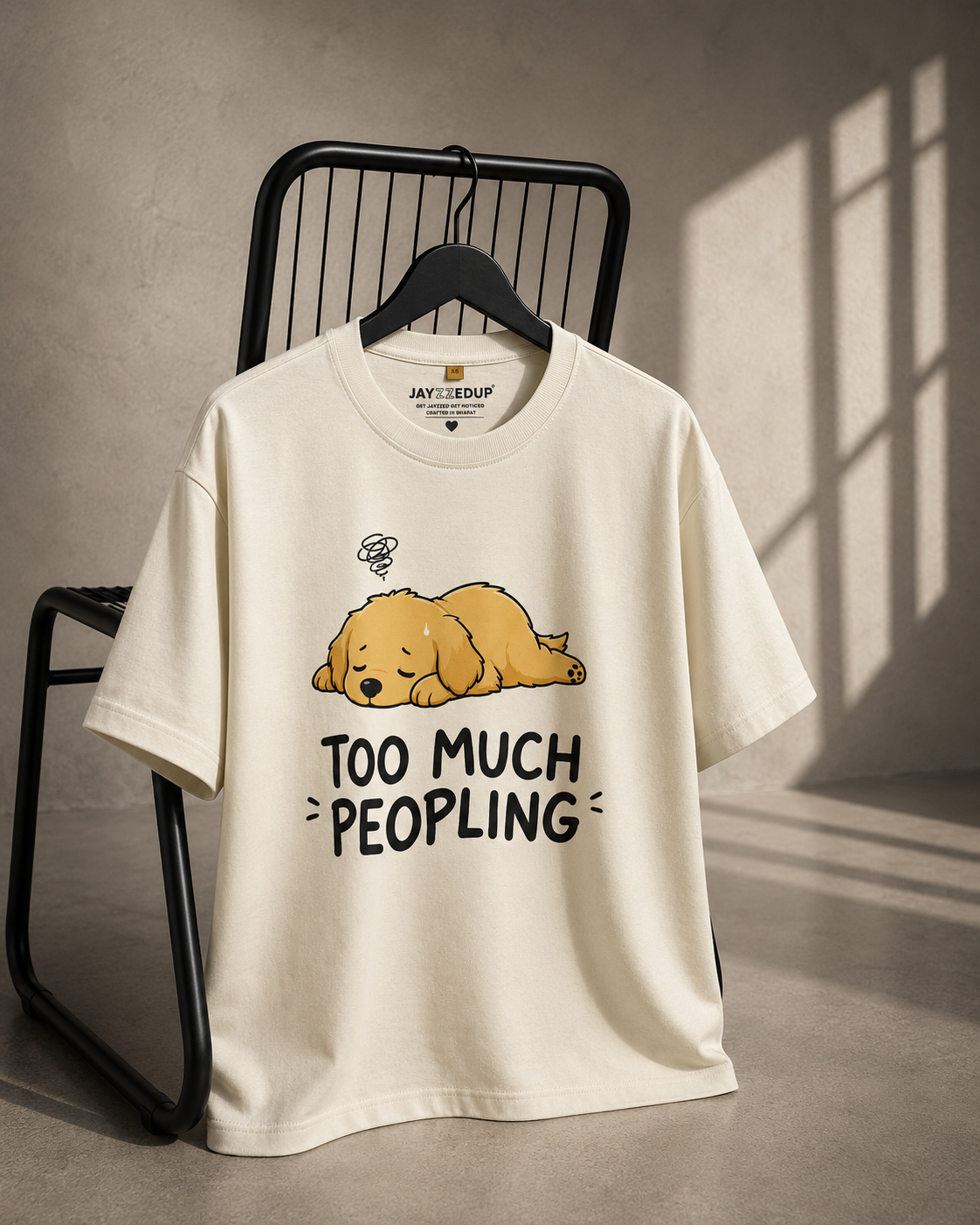 Cream oversized unisex graphic T-shirt featuring a sleepy puppy illustration with the quote "Too Much Peopling", made from 220–240 GSM bio-washed French Terry cotton.