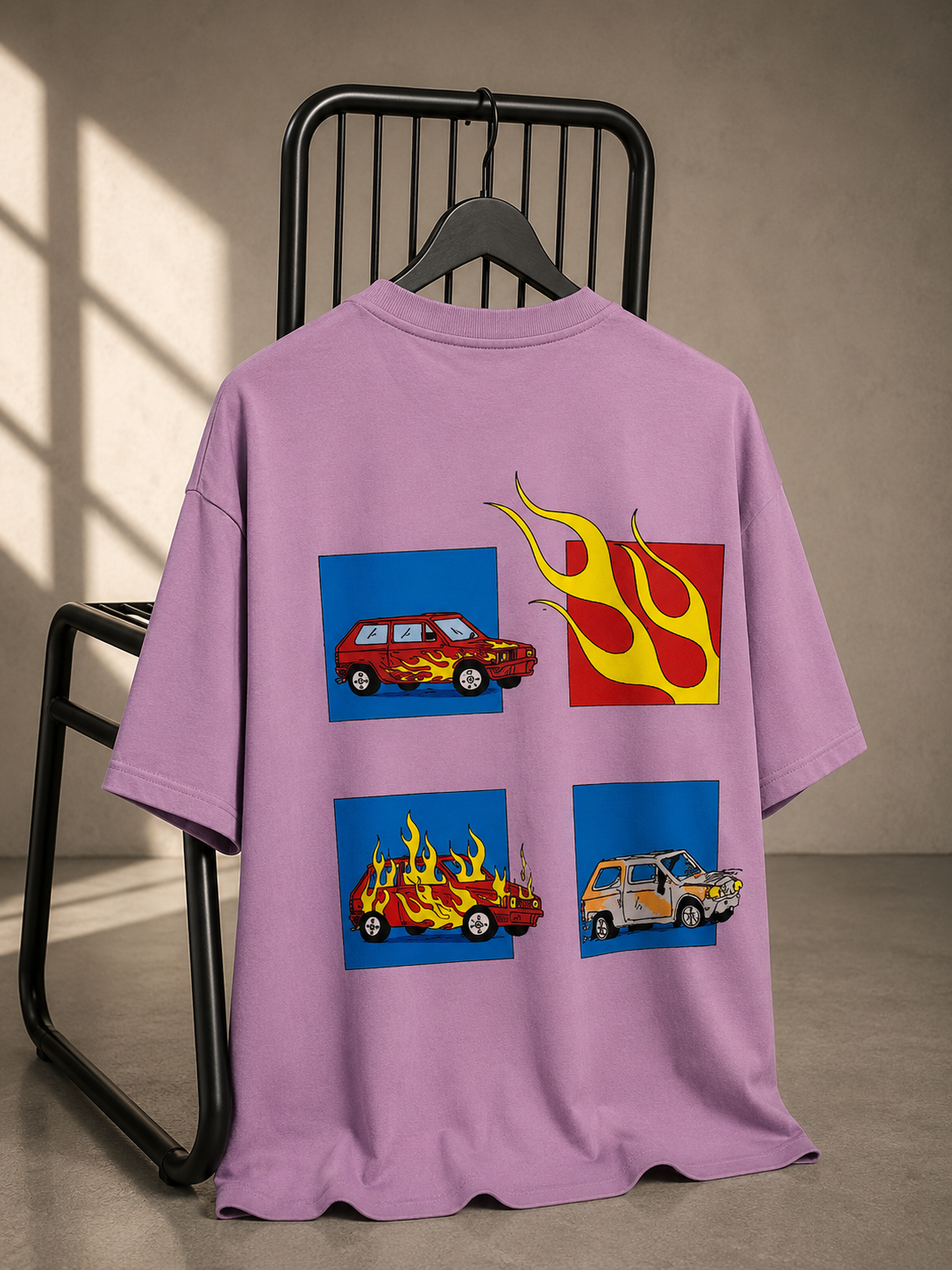Lavender oversized graphic T-shirt featuring illustrated car and flame artwork on the back.