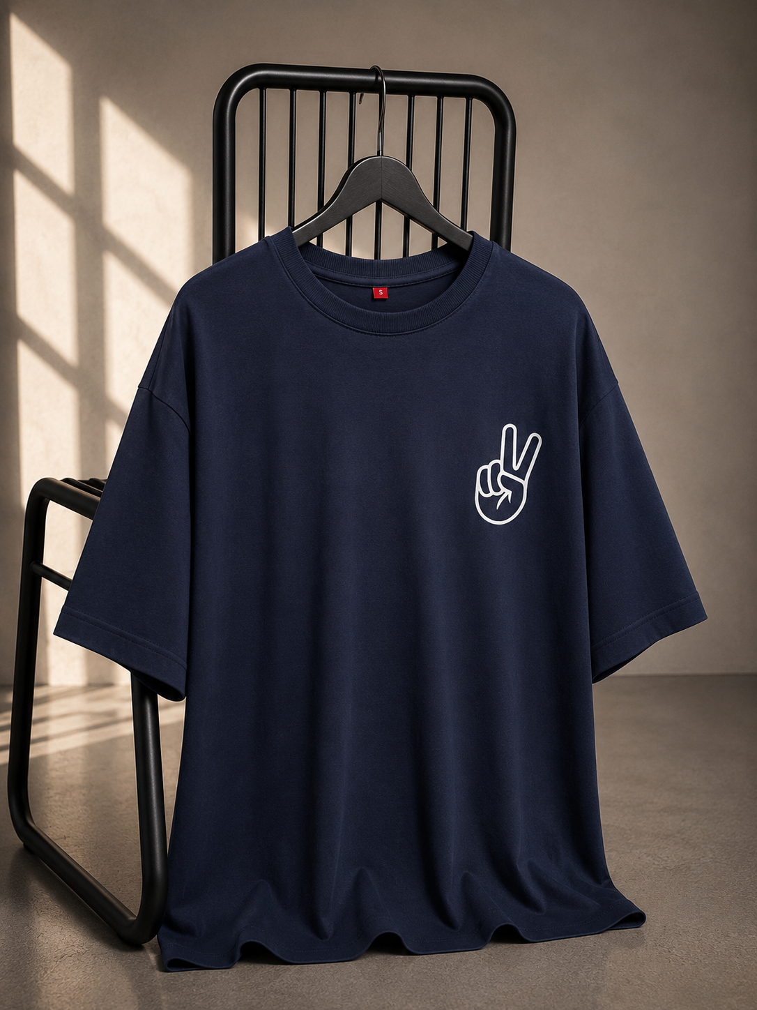 Navy oversized unisex graphic T-shirt featuring a minimal peace sign print on the chest, made from 220–240 GSM bio-washed French Terry cotton.