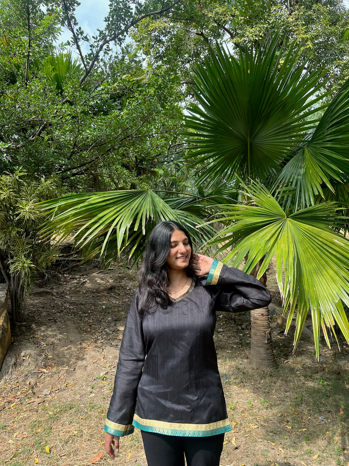 Black full sleeve kurti with teal and gold hem border