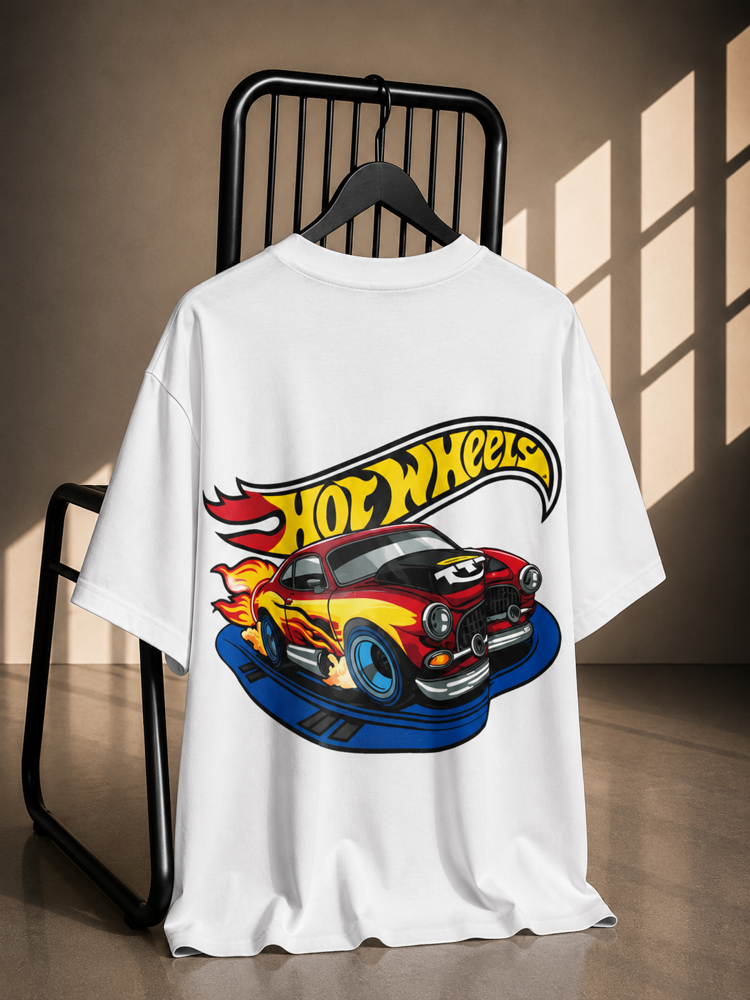 White oversized graphic T-shirt featuring a Hot Wheels racing car illustration on the back.
