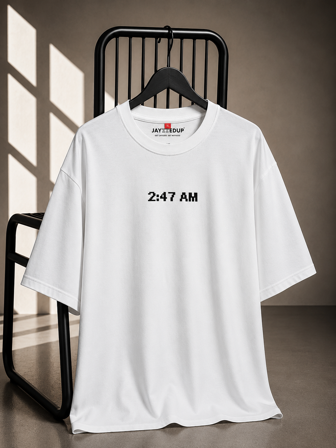 White oversized unisex graphic T-shirt made from 220–240 GSM bio-washed French Terry cotton with a minimal front chest print.